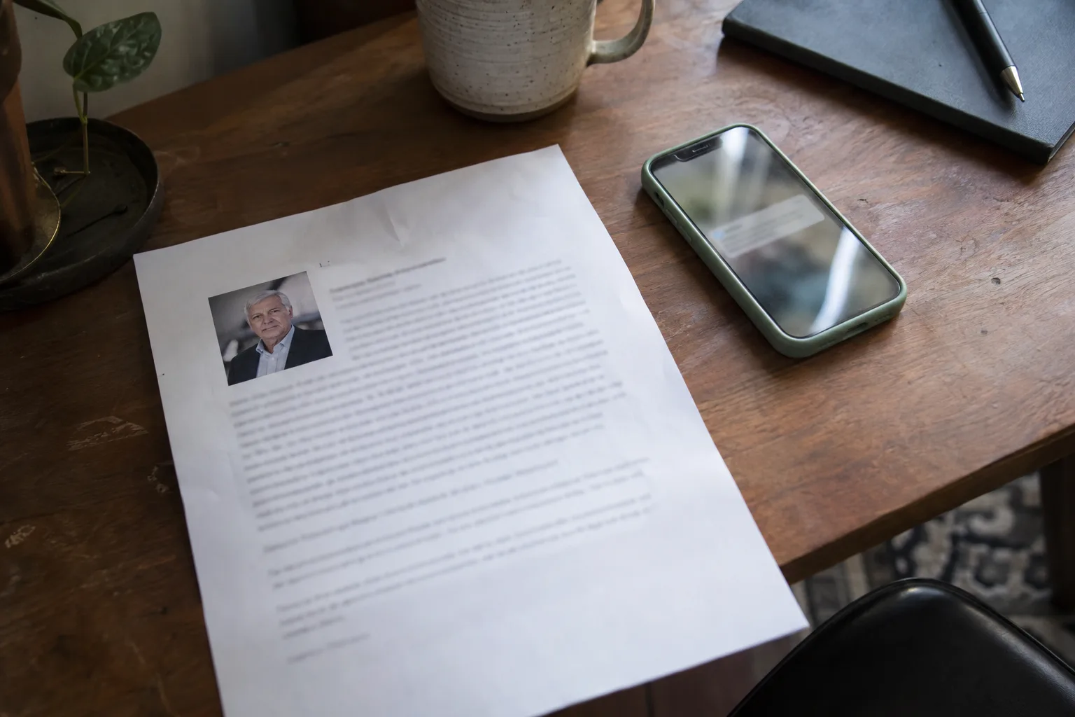 Printed expert profile with a headshot next to a phone showing a request alert